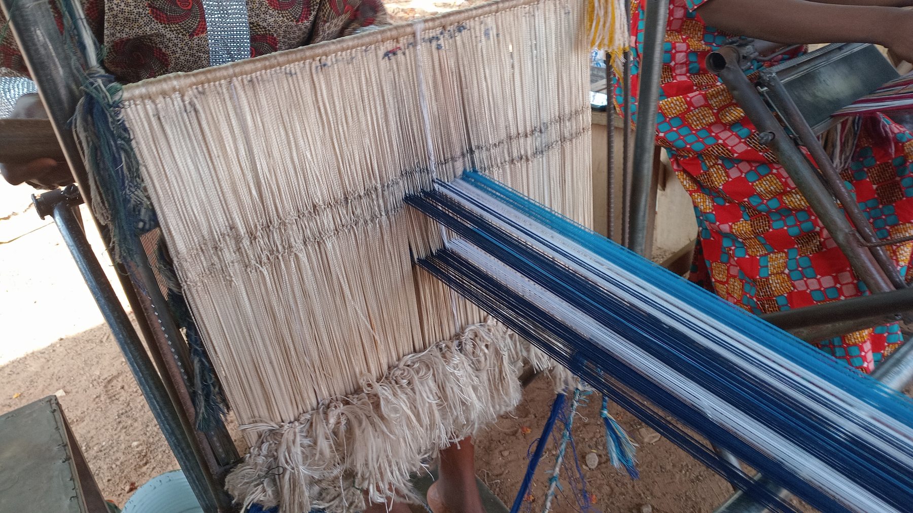 Weaver working at a traditional kente loom in Ghana